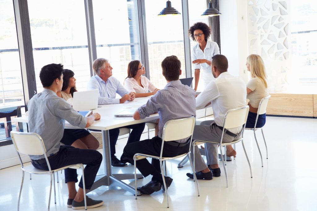 Businesswoman Presenting To Colleagues At A Meeting